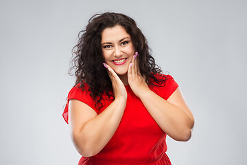 Image showing happy woman in red dress over grey background