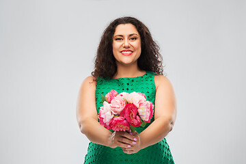 Image showing happy woman in green dress with flower bunch