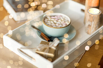 Image showing hot chocolate, christmas gift and candles on table