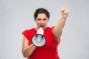 Image showing woman in red dress speaking to megaphone
