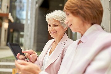 Image showing senior women with tablet computer in city