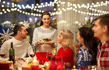 Image showing happy friends having christmas dinner at home