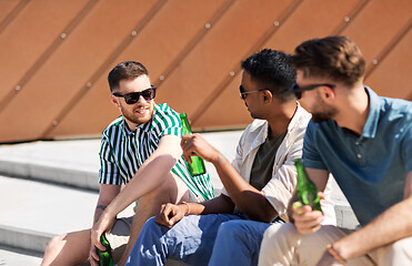 Image showing happy male friends drinking beer on street