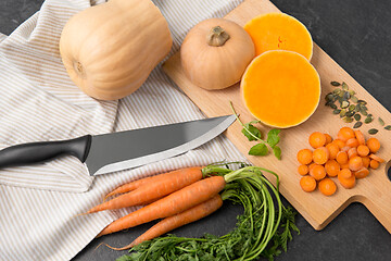 Image showing cut pumpkin, carrots and kitchen knife on table