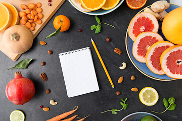 Image showing close up of notebook, fruits and vegetables