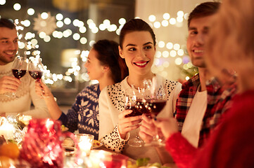 Image showing happy friends celebrating christmas at home feast