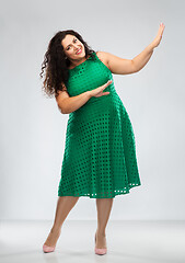 Image showing happy woman in green dress over posing