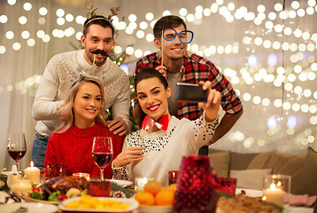 Image showing friends taking selfie at christmas dinner