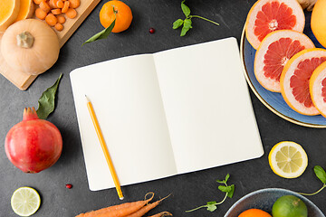 Image showing close up of notebook, fruits and vegetables