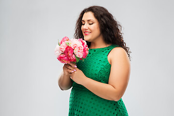 Image showing happy woman in green dress with flower bunch