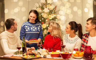 Image showing happy friends having christmas dinner at home