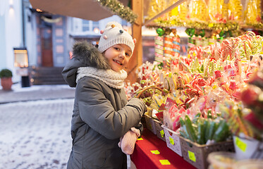 Image showing little girl choosing sweets at christmas market