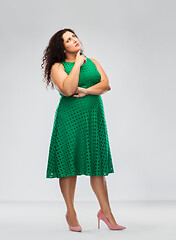 Image showing serious woman in green dress thinking