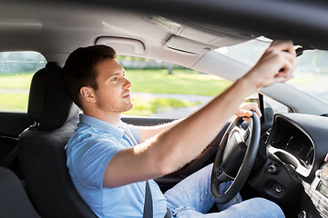 Image showing man or car driver adjusting mirror