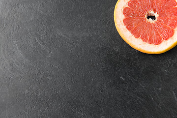 Image showing close up of fresh juicy grapefruit on slate board