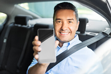 Image showing passenger or businessman showing smartphone in car