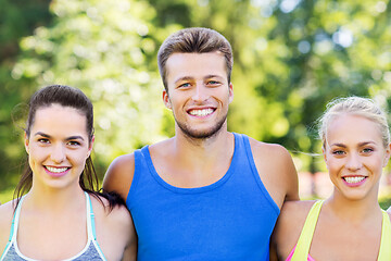 Image showing group of happy friends or sportsmen at summer park