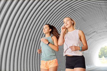 Image showing women or female friends with earphones running