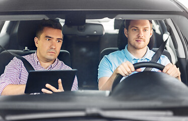 Image showing car driving school instructor and young driver