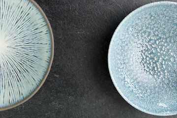 Image showing close up of blue ceramic plate on slate background