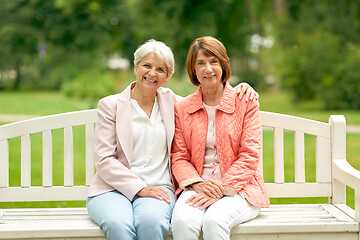 Image showing senior women or friends sitting on bench at park