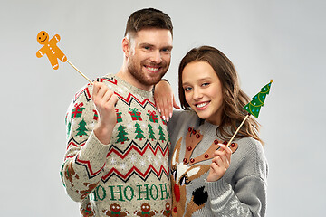 Image showing couple with christmas party props in ugly sweaters