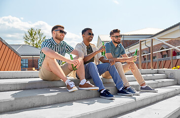 Image showing happy male friends drinking beer on street