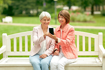 Image showing happy senior women with smartphone at summer park