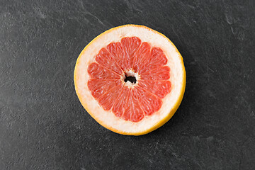 Image showing close up of fresh juicy grapefruit on slate board