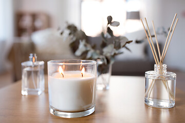 Image showing aroma reed diffuser, burning candle and perfume