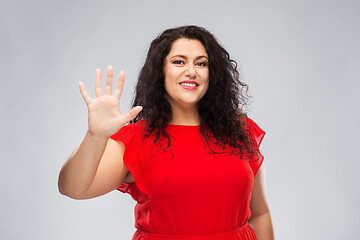 Image showing happy woman in red dress showing five fingers