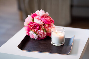 Image showing burning fragrance candle and flower bunch at home