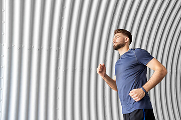 Image showing sporty young man running in tunnel