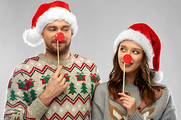 Image showing couple with christmas party props in ugly sweaters