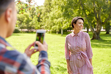 Image showing couple photographing by smartphone in park