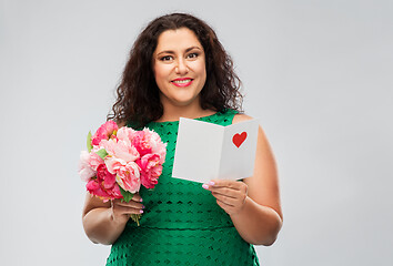 Image showing happy woman with flower bunch and greeting card