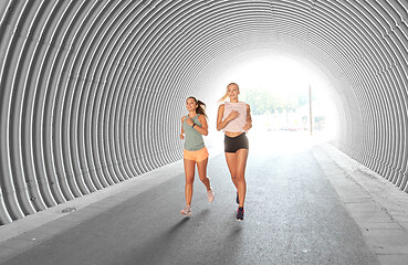 Image showing young women or female friends running outdoors