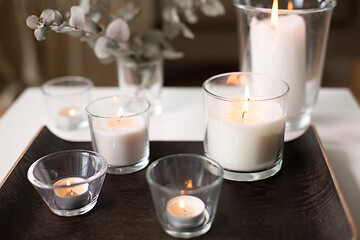 Image showing burning fragrance candles on table at cozy home