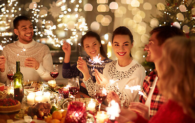 Image showing happy friends celebrating christmas at home feast