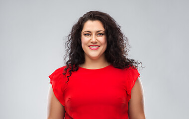 Image showing happy woman in red dress over grey background