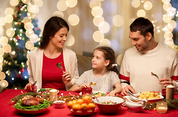 Image showing happy family having christmas dinner at home