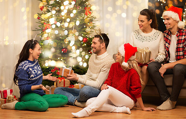 Image showing friends celebrating christmas and giving presents