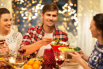 Image showing happy friends having christmas dinner at home