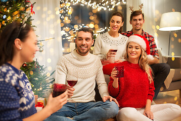 Image showing friends celebrating christmas and drinking wine