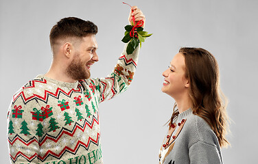 Image showing happy couple standing under the mistletoe