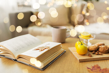 Image showing book, lemon, tea and cookies on table at home