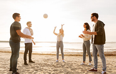 Image showing friends playing volleyball on beach in summer