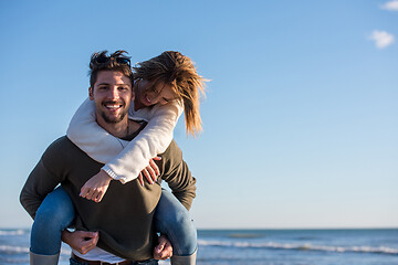 Image showing couple having fun at beach during autumn