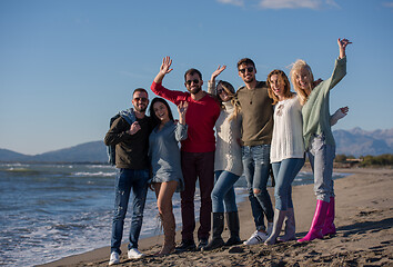 Image showing portrait of friends having fun on beach during autumn day