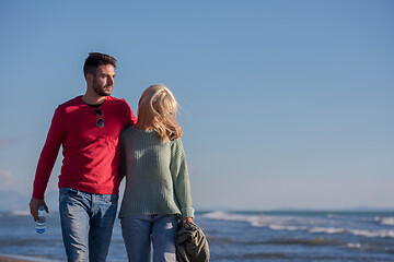 Image showing Loving young couple on a beach at autumn sunny day